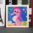 Puzzle enfant en bois avec une image d'hippocampe rose 